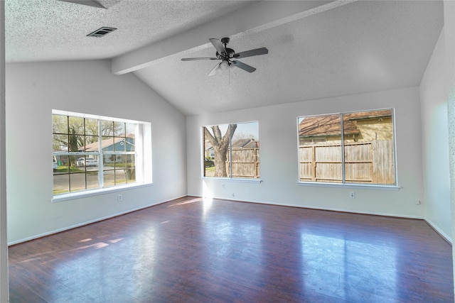 spare room with wood finished floors, a ceiling fan, visible vents, vaulted ceiling with beams, and a textured ceiling