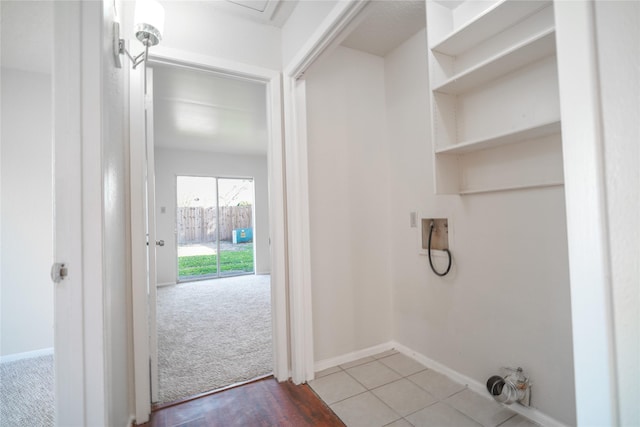 clothes washing area featuring laundry area, hookup for a washing machine, baseboards, and light carpet