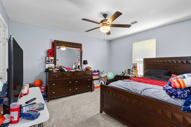 carpeted bedroom featuring visible vents and ceiling fan