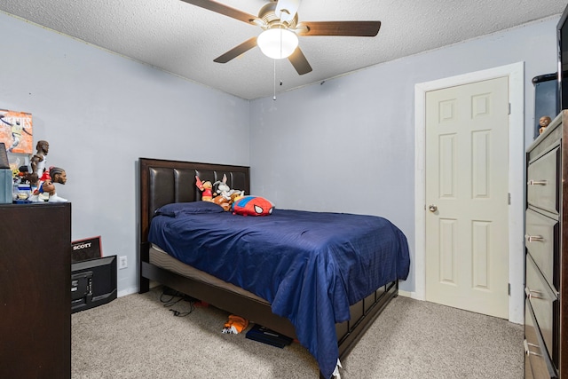 bedroom featuring a ceiling fan, a textured ceiling, and carpet flooring