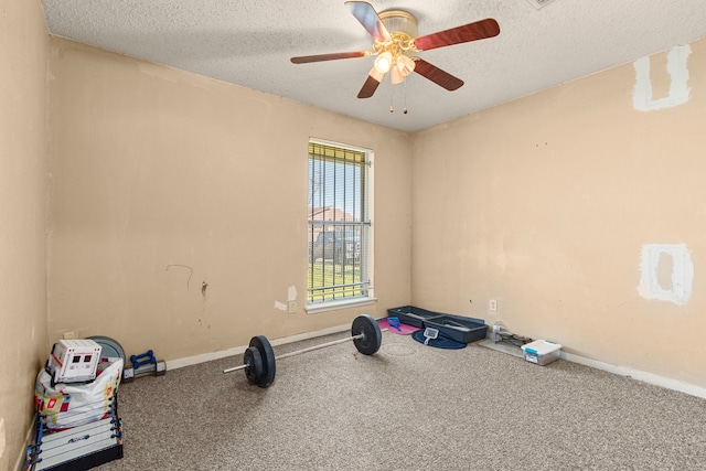 workout room featuring baseboards, a textured ceiling, ceiling fan, and carpet floors