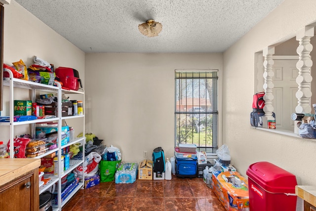 recreation room with a textured ceiling