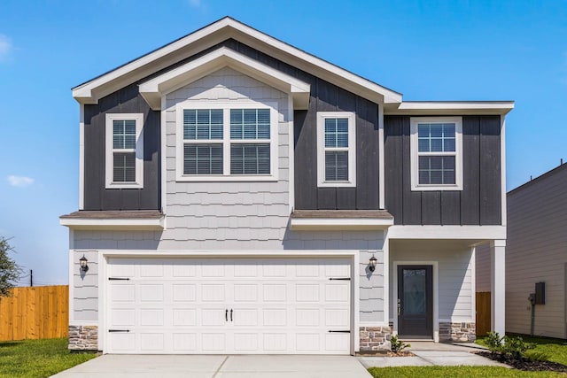 view of front facade with stone siding, concrete driveway, an attached garage, and fence