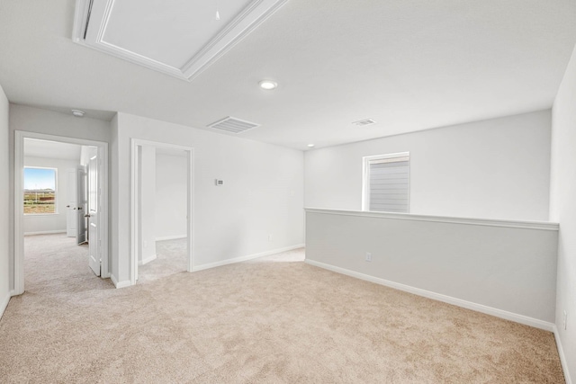 unfurnished room with visible vents, baseboards, and carpet