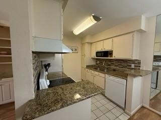 kitchen with light tile patterned flooring, decorative backsplash, white cabinets, dishwasher, and stainless steel microwave