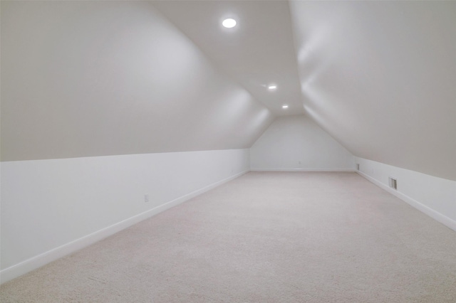 bonus room featuring visible vents, recessed lighting, baseboards, light colored carpet, and vaulted ceiling