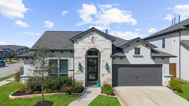 french country home with stone siding, stucco siding, driveway, and a shingled roof