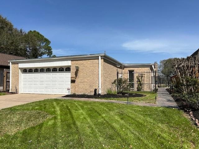 view of side of property with an attached garage, a lawn, driveway, and brick siding
