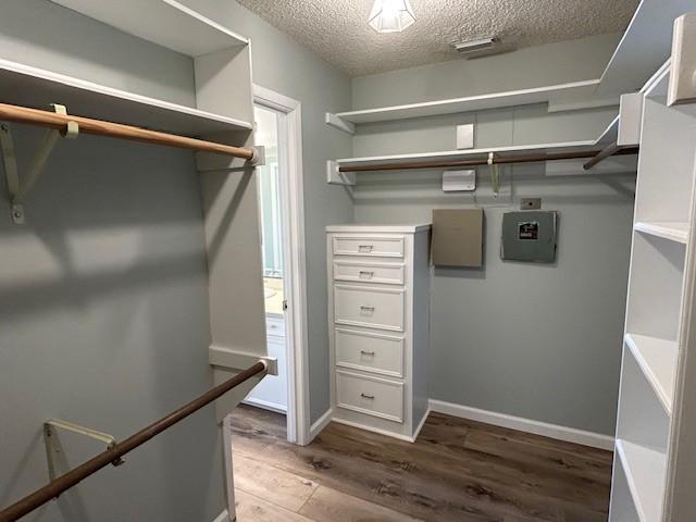 spacious closet with wood finished floors