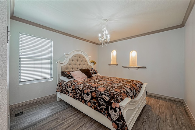 bedroom with a notable chandelier, crown molding, and wood finished floors