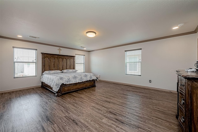 bedroom with visible vents, multiple windows, ornamental molding, and dark wood-style flooring