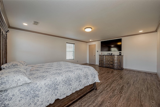 bedroom with visible vents, baseboards, dark wood-type flooring, and ornamental molding