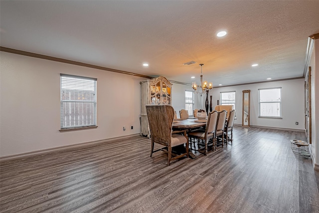 dining area featuring dark wood finished floors, visible vents, a chandelier, and a wealth of natural light