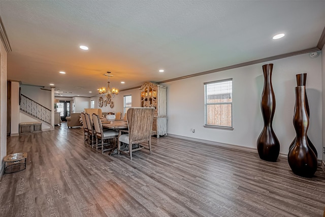 dining space with stairway, wood finished floors, and ornamental molding