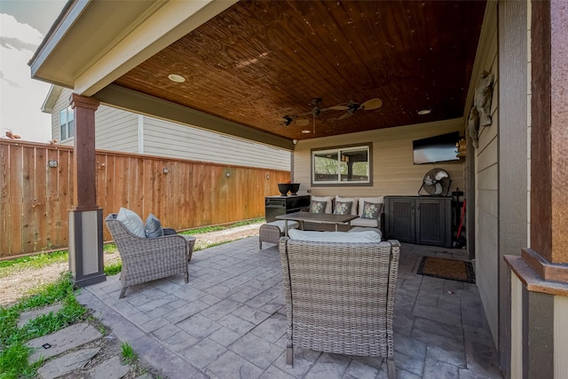 view of patio / terrace with outdoor lounge area, fence, and a ceiling fan