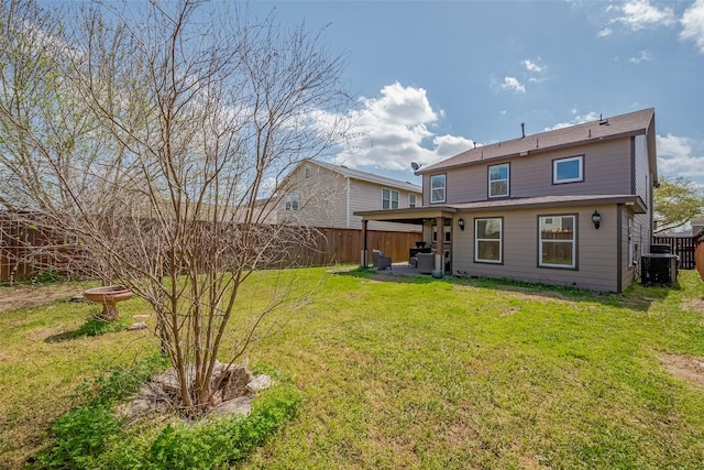 rear view of property featuring a patio, central air condition unit, a lawn, and a fenced backyard