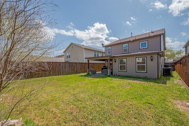 rear view of house with a yard, a fenced backyard, and central AC