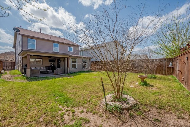 back of house with a lawn, an outdoor hangout area, a fenced backyard, and a patio