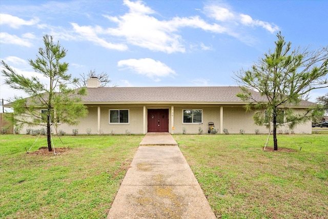 ranch-style house with a front lawn, brick siding, and a chimney