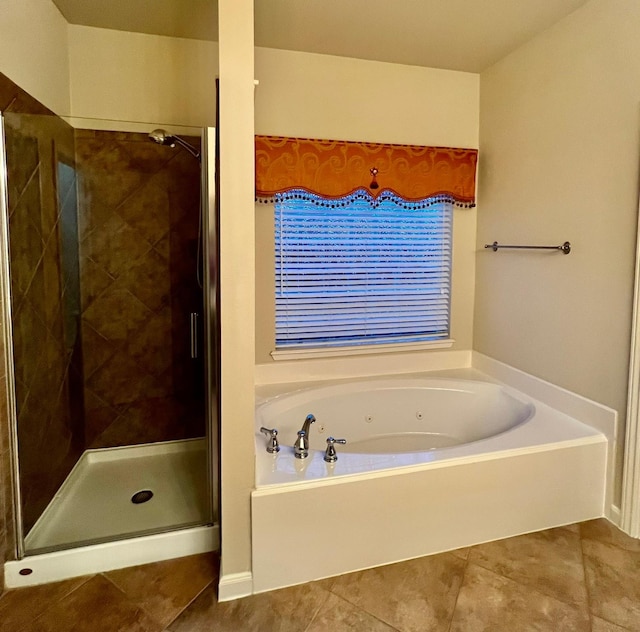 full bathroom with tile patterned flooring, a tub with jets, and a stall shower