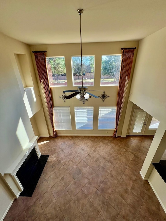 interior space with baseboards and ceiling fan