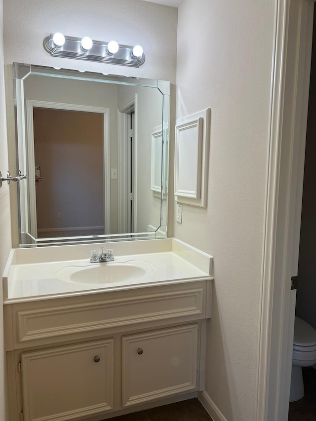 bathroom featuring toilet and vanity