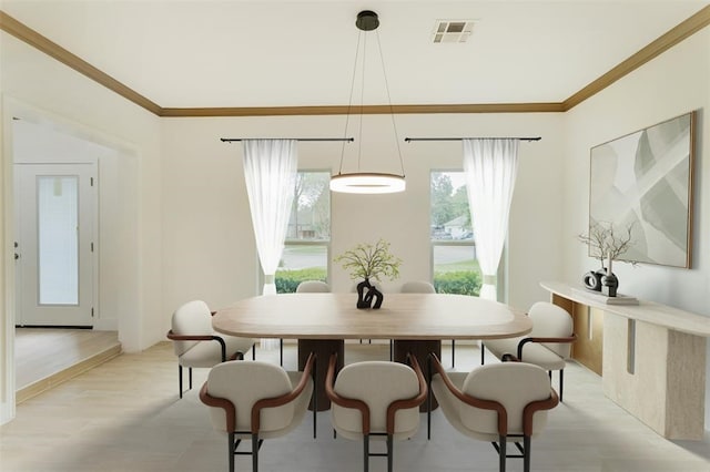 dining area with light wood-type flooring, visible vents, and ornamental molding