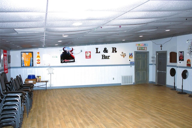 miscellaneous room featuring wood finished floors, a paneled ceiling, and visible vents