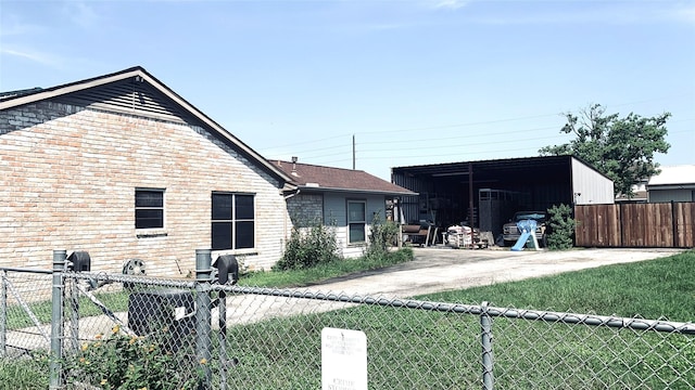 rear view of property with fence and brick siding