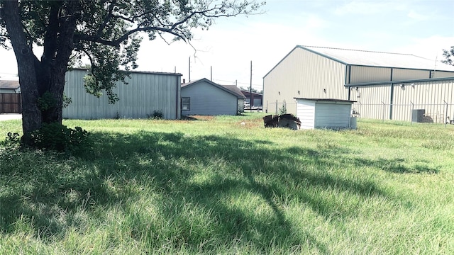 view of yard featuring an outbuilding and a pole building