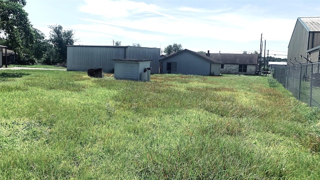 view of yard with an outbuilding and fence