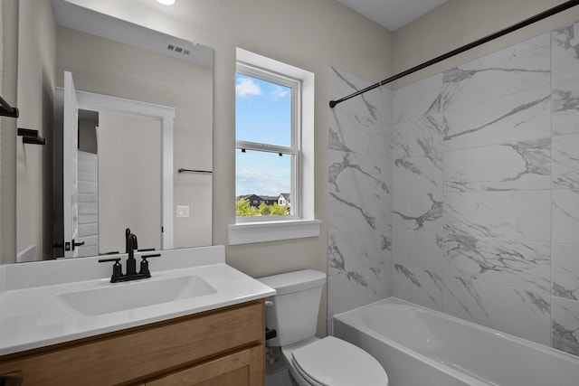 bathroom featuring visible vents, toilet, shower / bath combination, and vanity