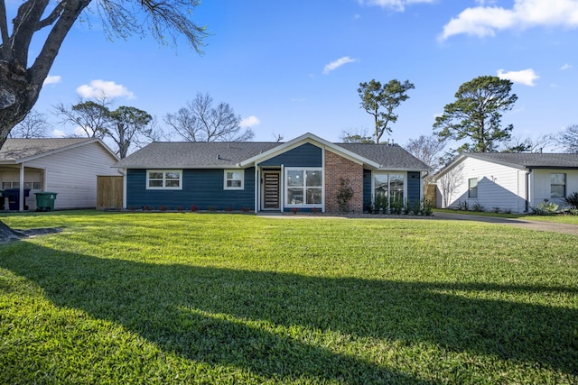 rear view of property with a lawn