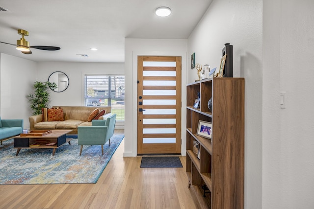 entrance foyer featuring visible vents, ceiling fan, and wood finished floors