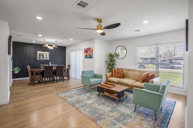 living room with recessed lighting, visible vents, light wood-type flooring, and ceiling fan