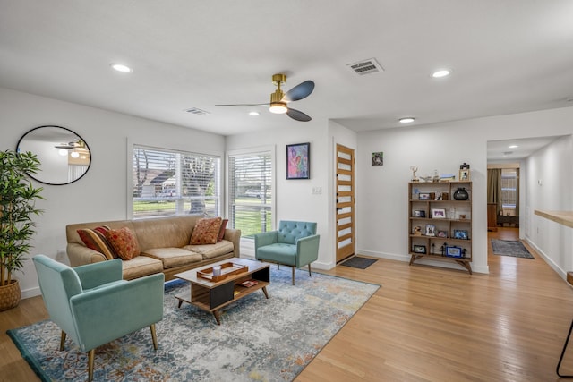 living area featuring recessed lighting, visible vents, light wood-style flooring, and a ceiling fan