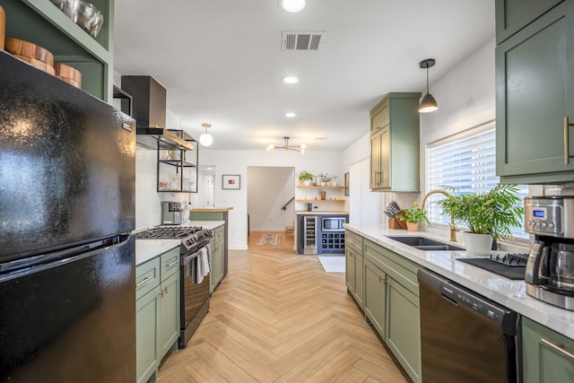 kitchen featuring open shelves, green cabinetry, decorative backsplash, black appliances, and a sink