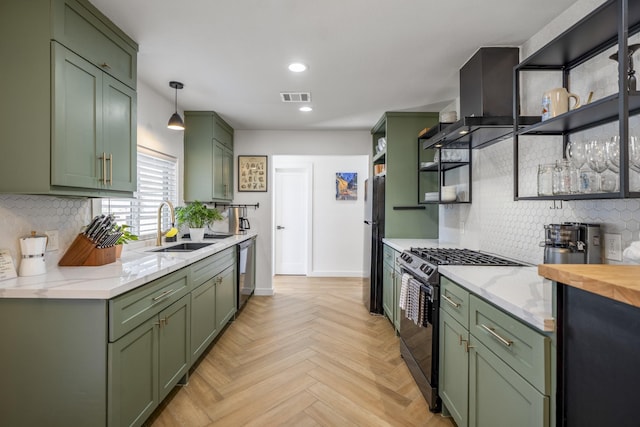 kitchen featuring visible vents, open shelves, a sink, stainless steel appliances, and green cabinets