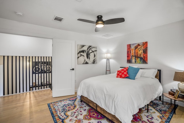 bedroom featuring visible vents, wood finished floors, and a ceiling fan