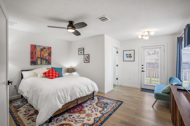 bedroom featuring visible vents, baseboards, light wood-style flooring, and access to outside