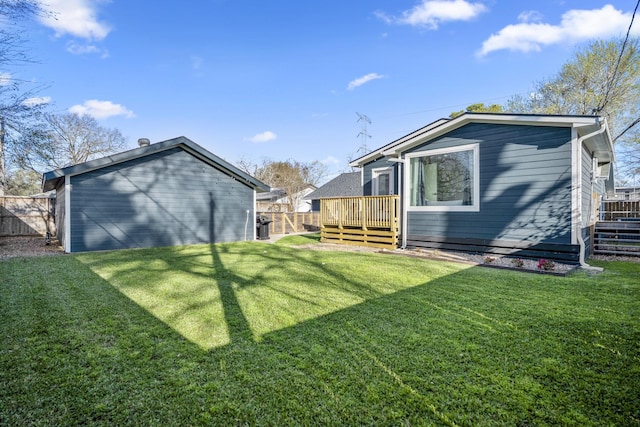 view of yard with a deck and fence