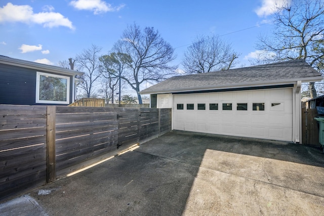 detached garage featuring fence