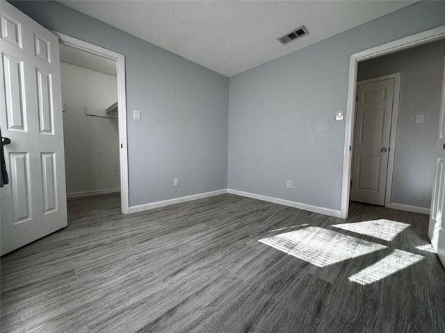 unfurnished room featuring dark wood-style floors and baseboards