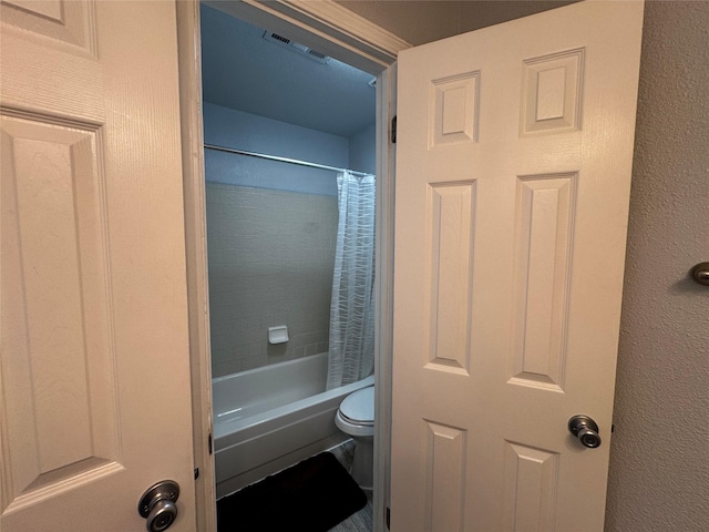 bathroom with visible vents, shower / bath combination with curtain, and toilet