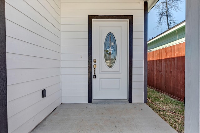 doorway to property with fence