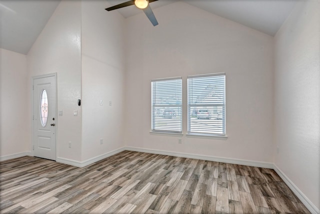 entrance foyer with baseboards, high vaulted ceiling, light wood-style flooring, and a ceiling fan