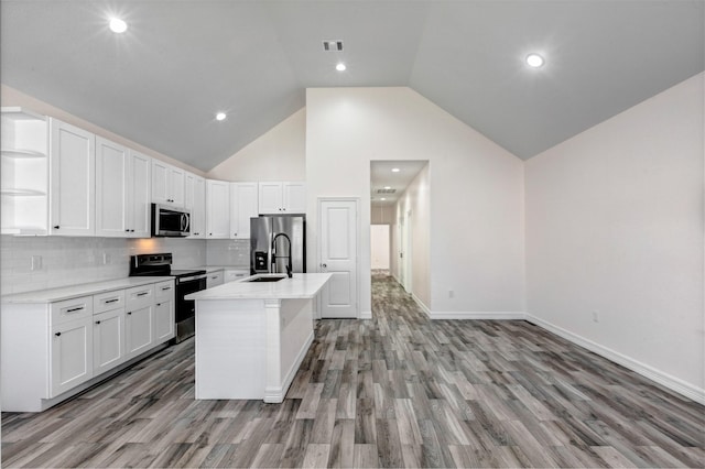 kitchen with open shelves, appliances with stainless steel finishes, white cabinets, and a sink