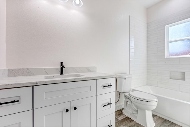 bathroom featuring vanity, toilet, and wood finished floors