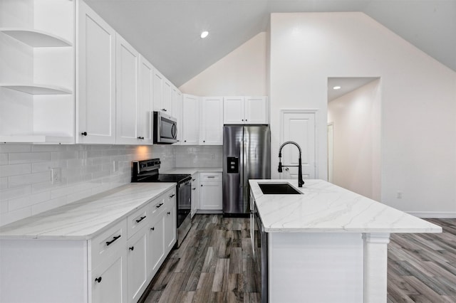 kitchen featuring open shelves, an island with sink, a sink, white cabinets, and appliances with stainless steel finishes