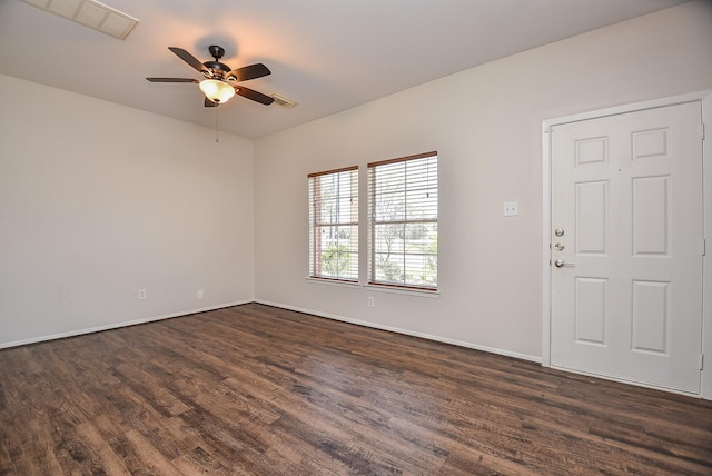 unfurnished room featuring dark wood-type flooring, visible vents, baseboards, and ceiling fan